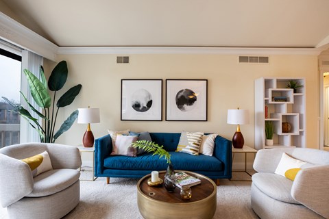 a living room with a blue couch and chairs and a coffee table